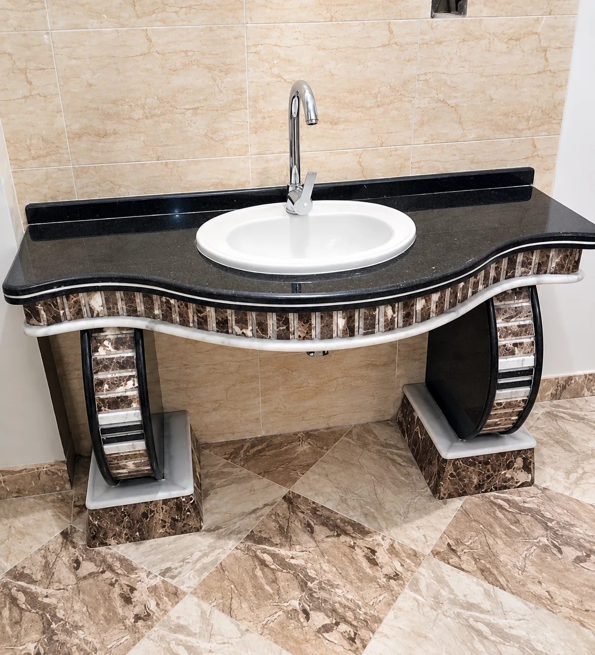 Detailed stone bathroom vanity and marble flooring