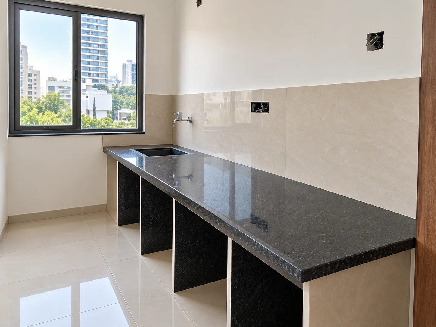 Polished black granite kitchen counter with a city view